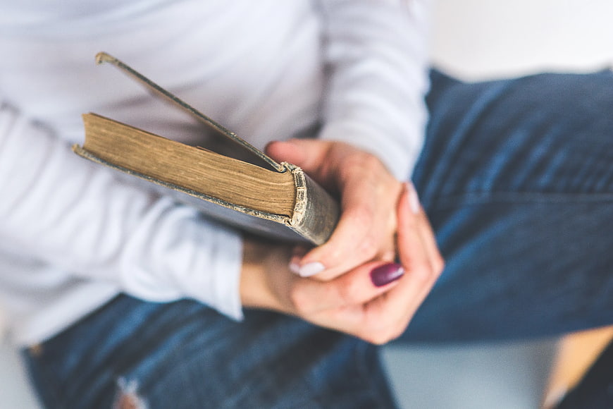 Close-up of hands holding a vintage book