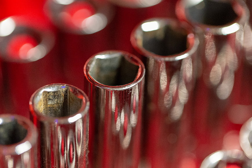Close-up of Chrome Ratchet Sockets on Red Background