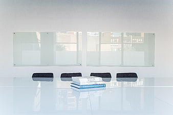 Minimalist modern office meeting room with glass table and books