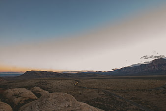 Desert landscape with winding road at sunset