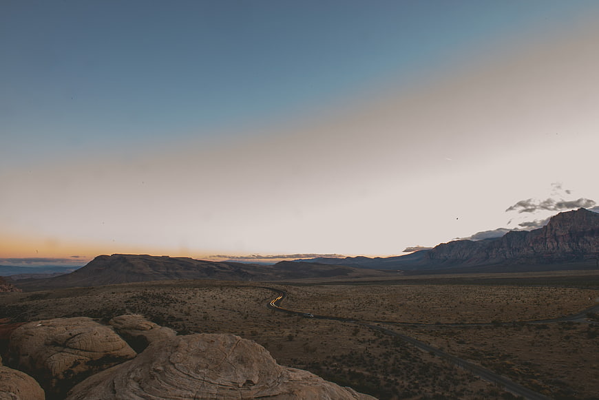 Desert landscape with winding road at sunset