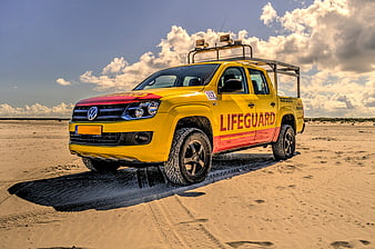 Yellow Lifeguard Pickup Truck on Sandy Beach