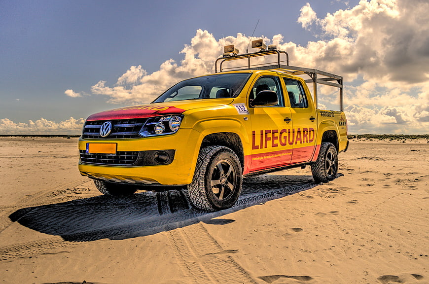 Yellow Lifeguard Pickup Truck on Sandy Beach
