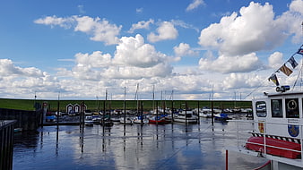 Harbor with boats under blue sky with clouds