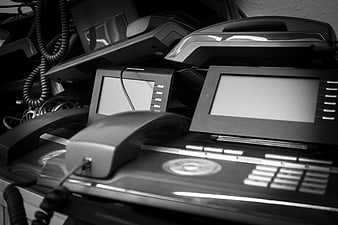 Stack of discarded office telephones and electronic waste