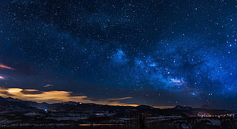 Milky Way Galaxy Over Snowy Mountain Range at Night