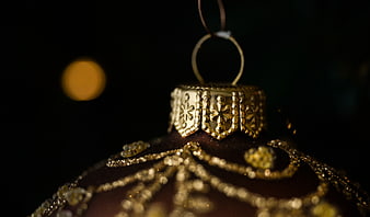 Close-up of Gold Christmas Ornament with Snowflake Details