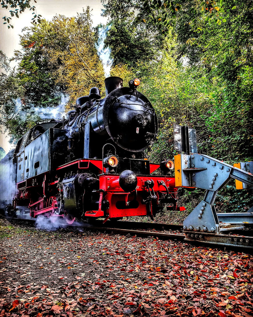 Vintage Steam Locomotive on Autumn Railroad Tracks