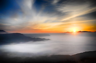 Sunset Over Sea of Clouds in Mountain Valley