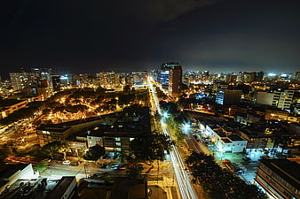 Aerial Night View of City with Light Trails and Urban Skyline
