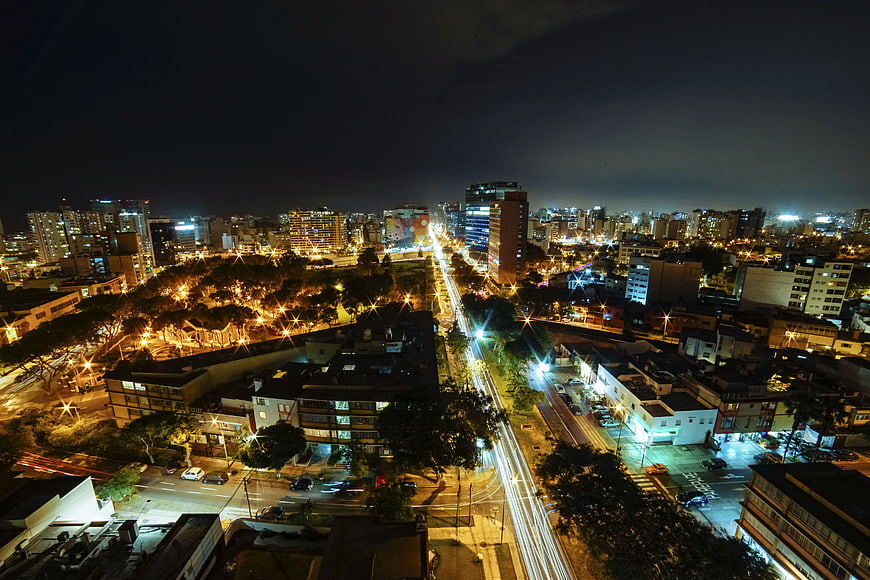 Aerial Night View of City with Light Trails and Urban Skyline