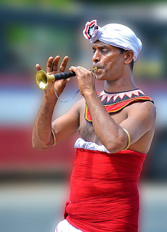 Indian Man Playing Traditional Brass Horn Instrument