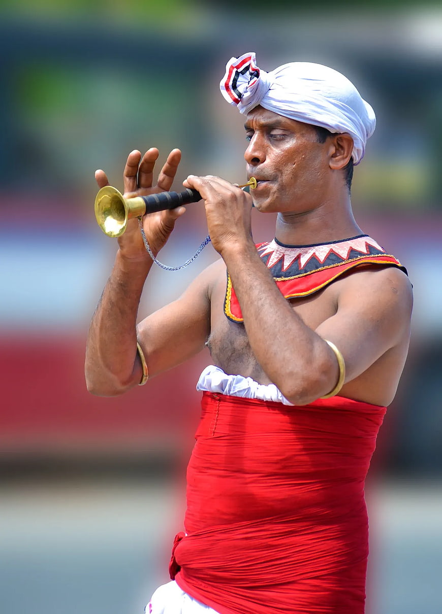 Indian Man Playing Traditional Brass Horn Instrument