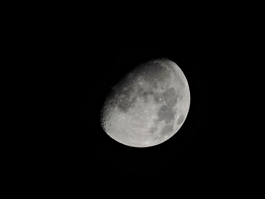 Gibbous Moon with Craters Against Black Night Sky