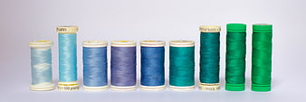 Colorful spools of sewing thread arranged in a row