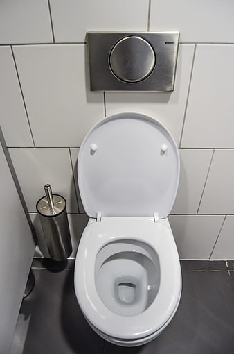 Modern white wall-hung toilet with chrome flush plate