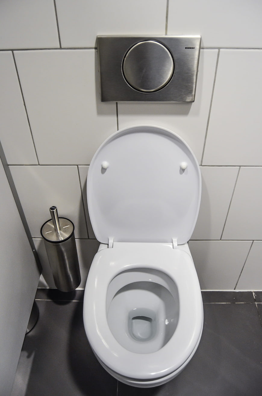 Modern white wall-hung toilet with chrome flush plate