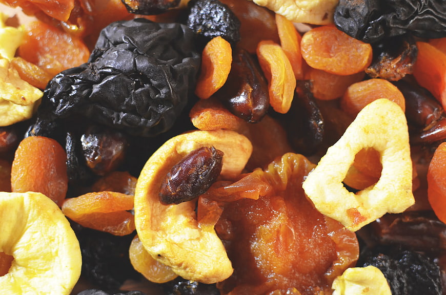 Close-up of mixed dried fruits including apricots, prunes, and apple rings