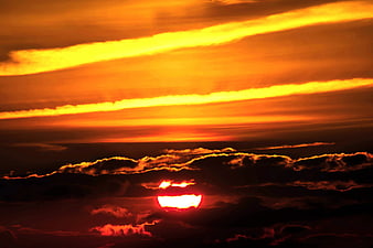 Dramatic Orange Sunset Sky With Dark Clouds And Sun