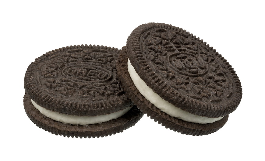Two Chocolate Sandwich Cookies With White Cream Filling On White Background