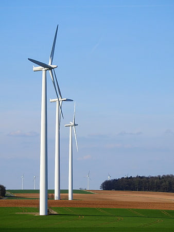 White Wind Turbines in Green and Brown Fields