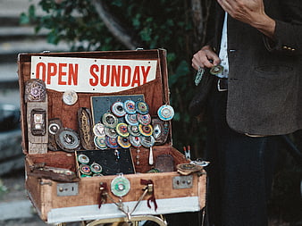 Vintage suitcase jewelry display with Open Sunday sign