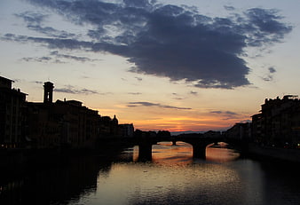 Silhouette of Ponte Vecchio at Sunset Over River Arno
