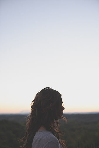 Woman Silhouette Looking at Sunset Horizon