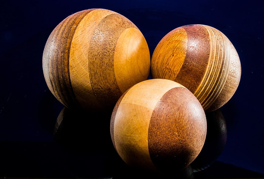 Handcrafted Wooden Spheres on Dark Blue Background