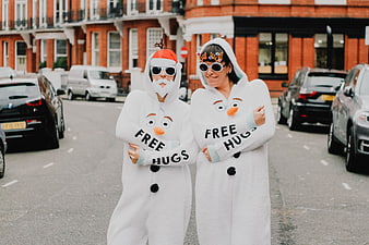 Two People in Olaf Snowman Onesies on City Street