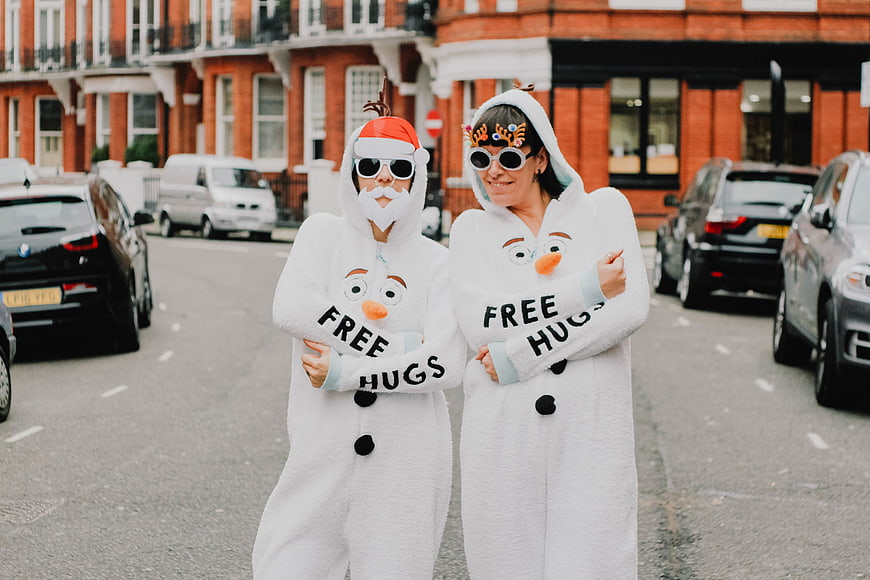 Two People in Olaf Snowman Onesies on City Street