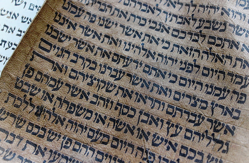 Close-up of ancient Hebrew manuscript text on aged parchment