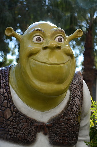 Close-up of Shrek statue with green skin and brown vest