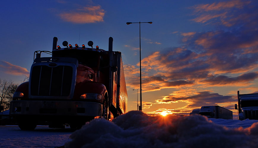 Red Semi Truck Silhouette at Winter Sunset