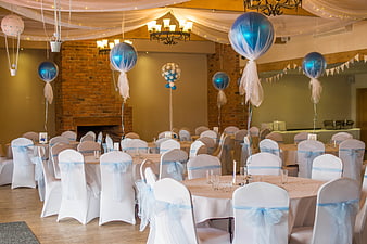 Blue and white christening party room with balloons and chair covers