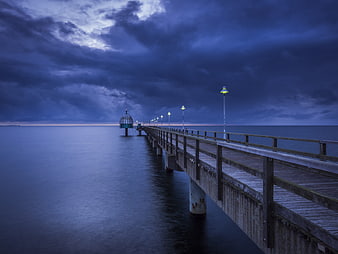 Long Exposure Pier at Blue Hour with Stormy Sky