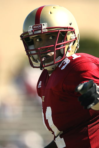 American Football Player in Red Jersey and Gold Helmet
