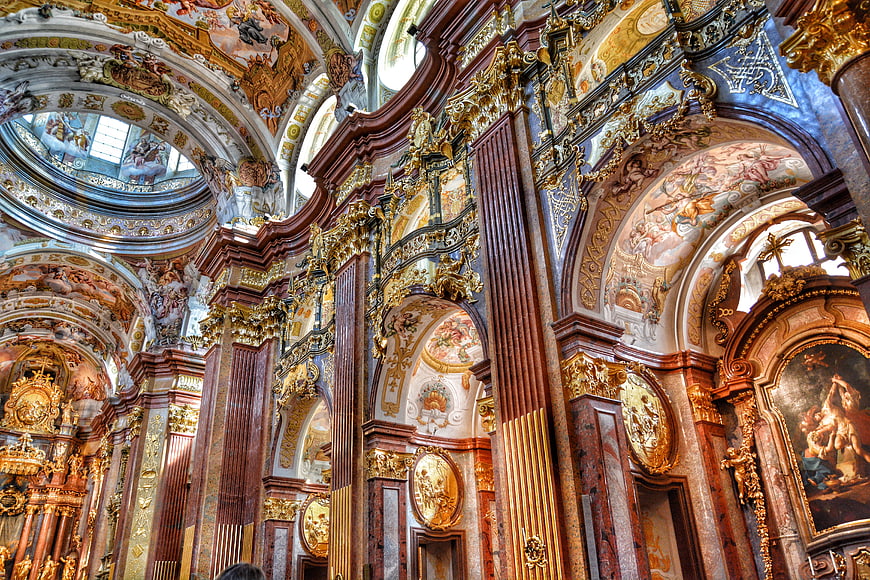 Ornate Baroque Church Interior with Gold Details and Frescoes