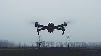 Black Drone Flying Over Winter Field