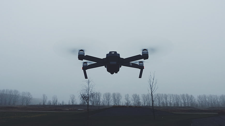 Black Drone Flying Over Winter Field