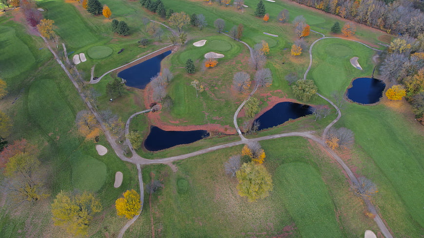 Aerial View of Golf Course with Autumn Foliage and Ponds