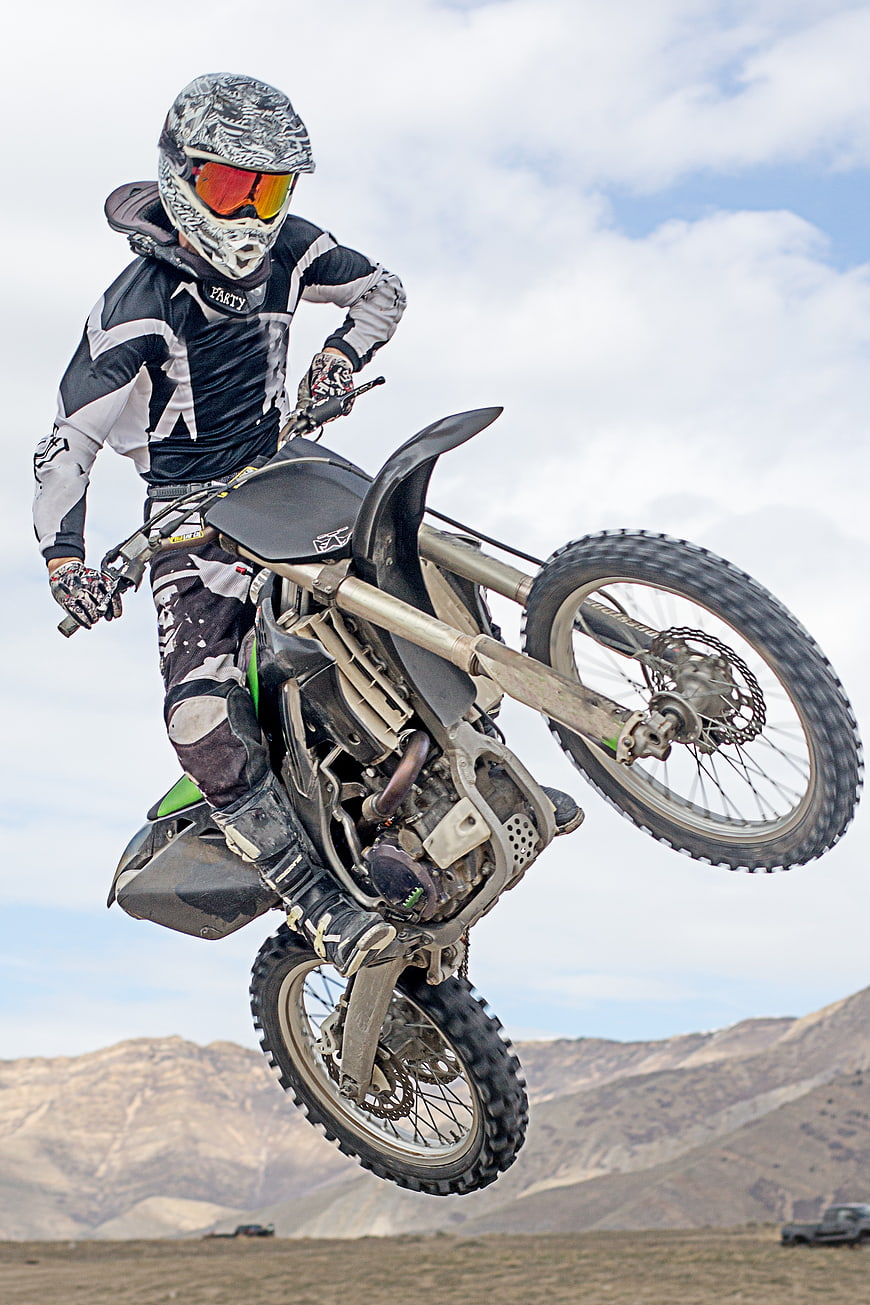 Motocross Rider Performing Freestyle Jump in Desert Landscape