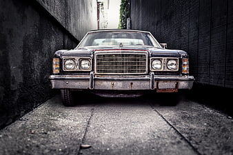 Vintage Black Ford Sedan in Narrow Alley