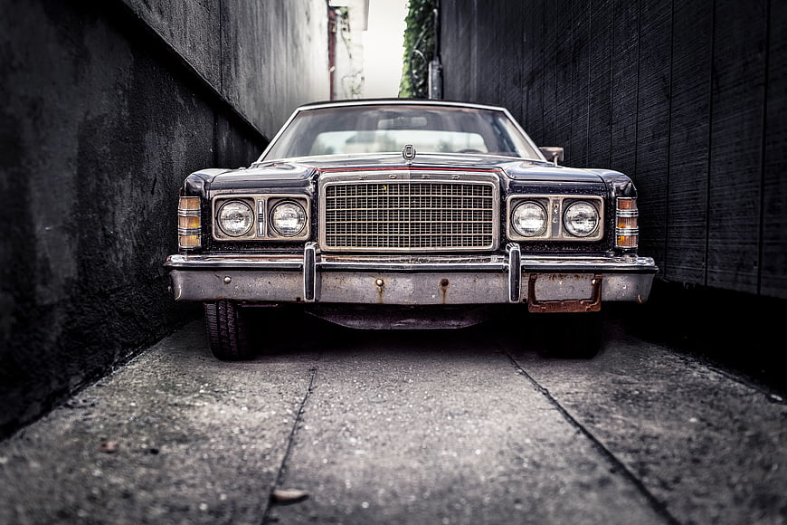 Vintage Black Ford Sedan in Narrow Alley