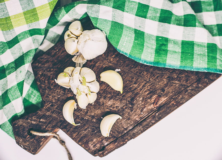 Fresh Garlic on Rustic Wooden Board with Green Checkered Cloth