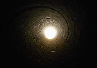 Illuminated Concrete Tunnel Interior With Bright Exit Light