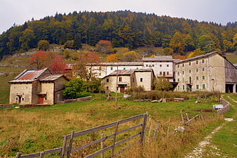Rustic Italian village in autumn with forested hills