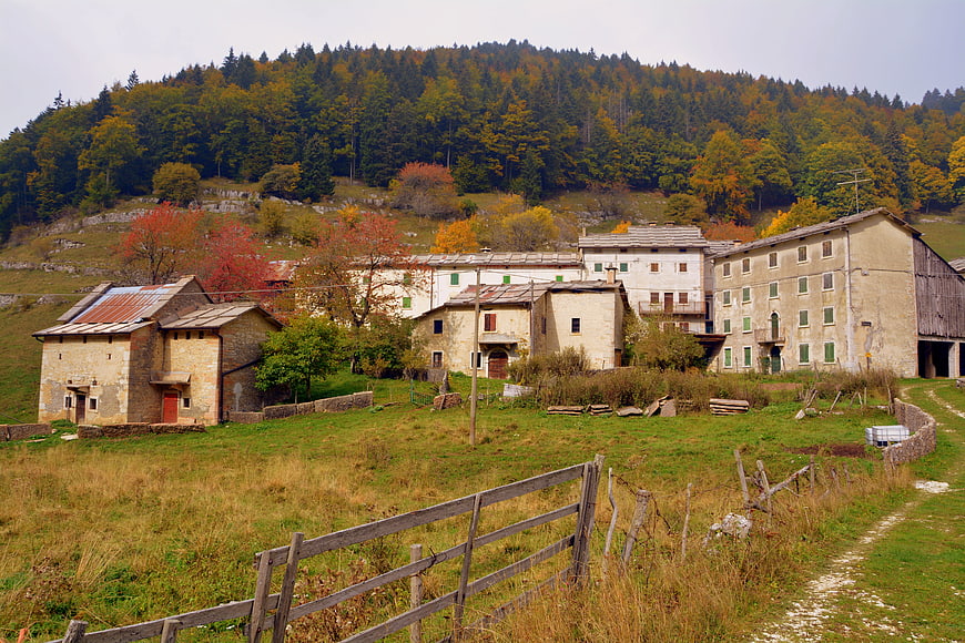 Rustic Italian village in autumn with forested hills