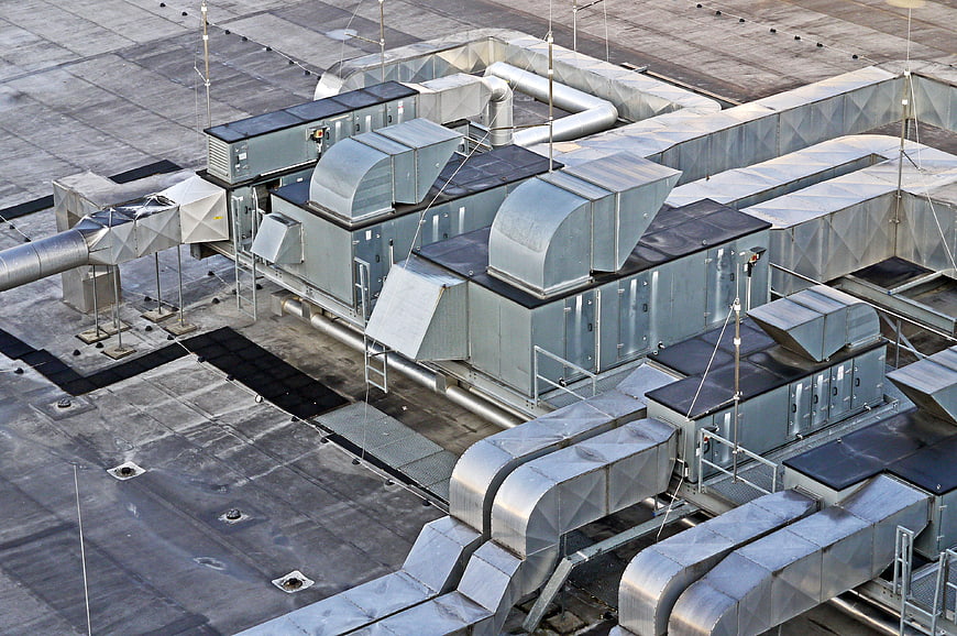 Aerial view of industrial HVAC ventilation units on a flat roof