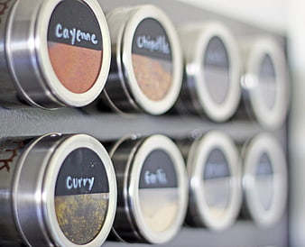Top View of Labeled Spice Jars on Kitchen Shelf